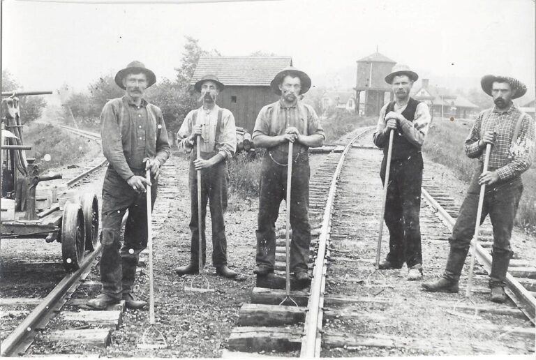 In an undated photo, here you see a crew of Railroad workers in town with our Depot